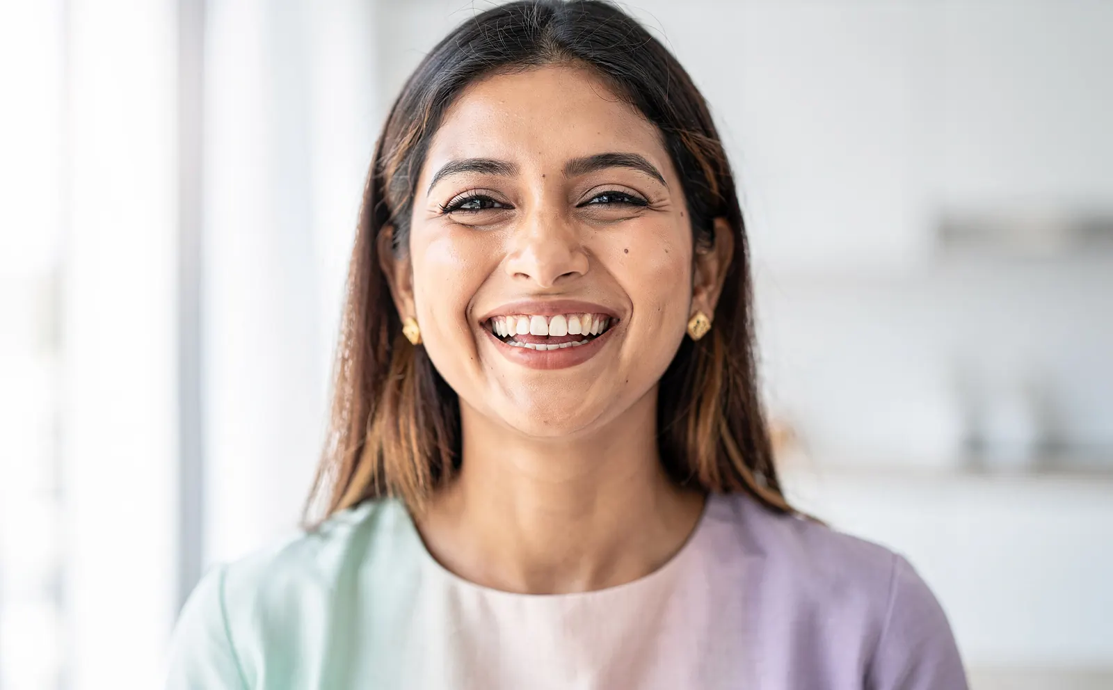 A young woman laughing, the smile close up