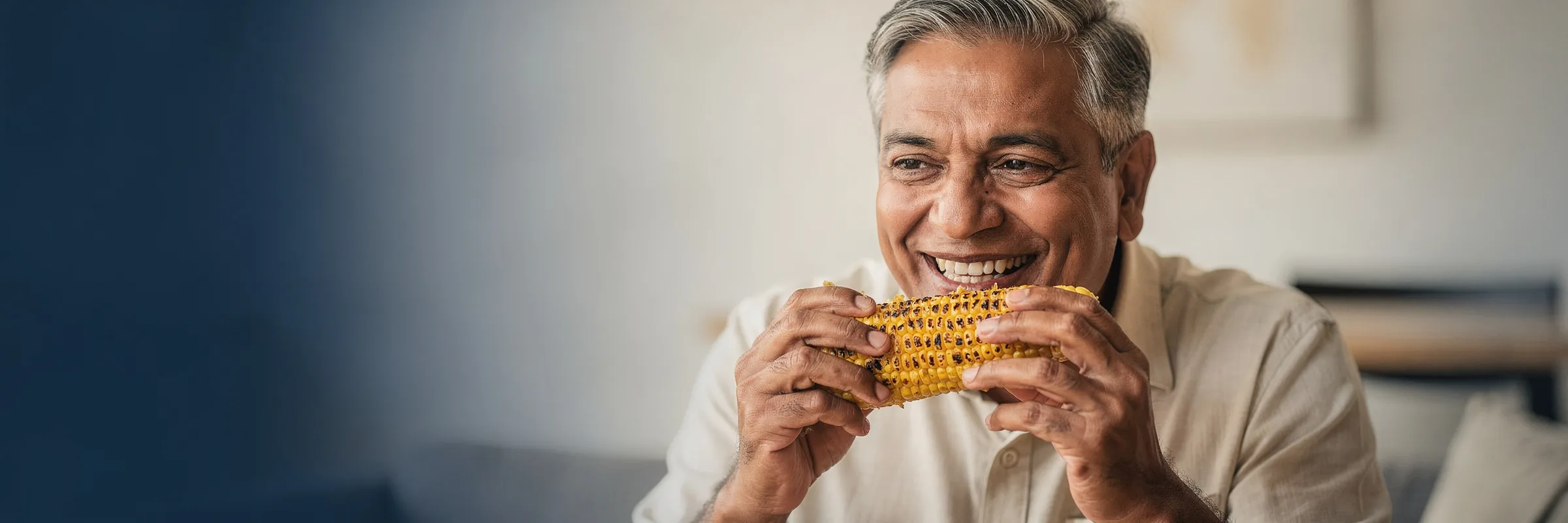 Illustrative picture: a man biting into roasted corn with confidence