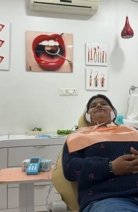 A patient undergoing Quad TENS therapy for TMJ jaw pain at Smile Gallery Bhopal